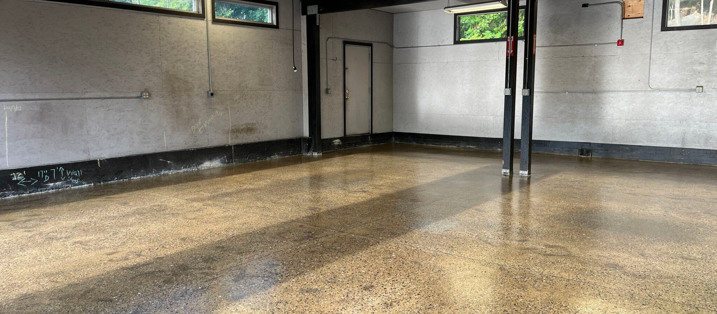 Polished concrete floor with exposed aggregate in a shop room