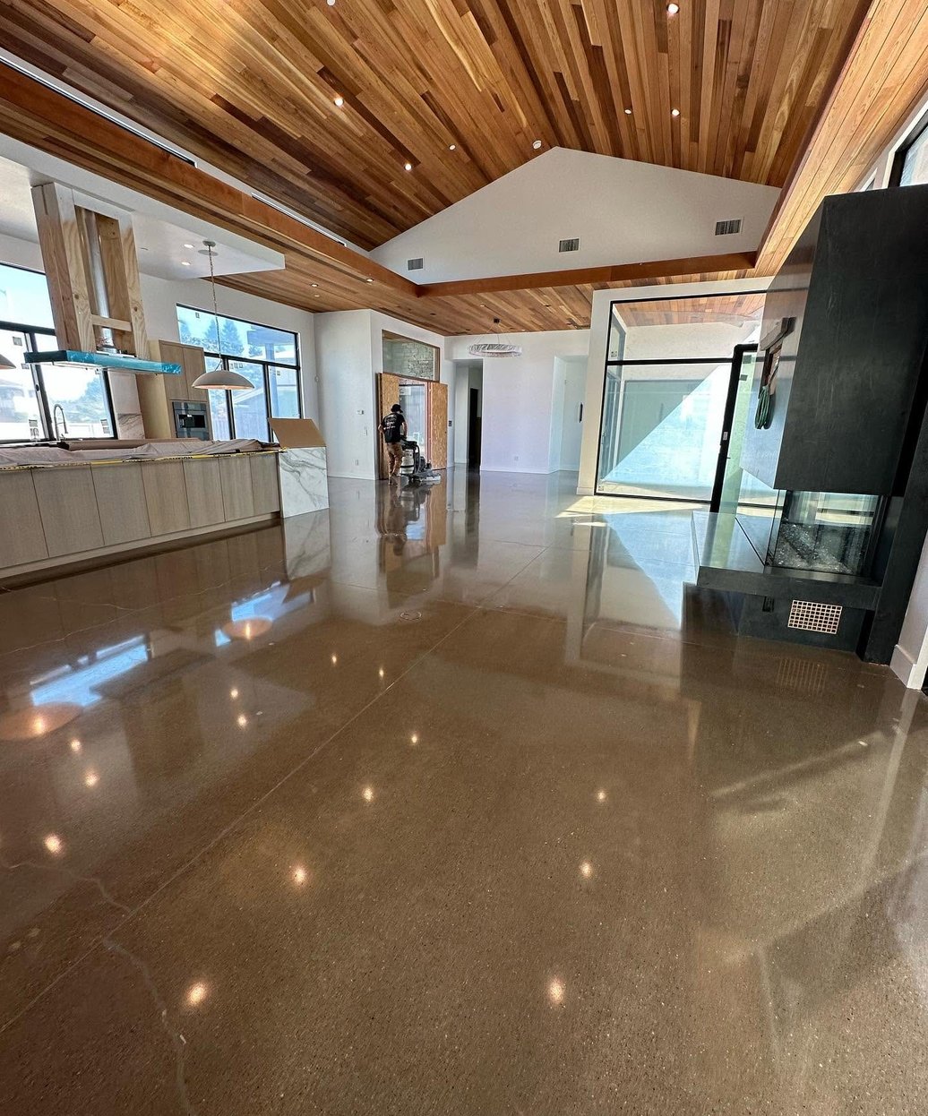 Polished concrete floor in a showroom with a wood plank ceiling