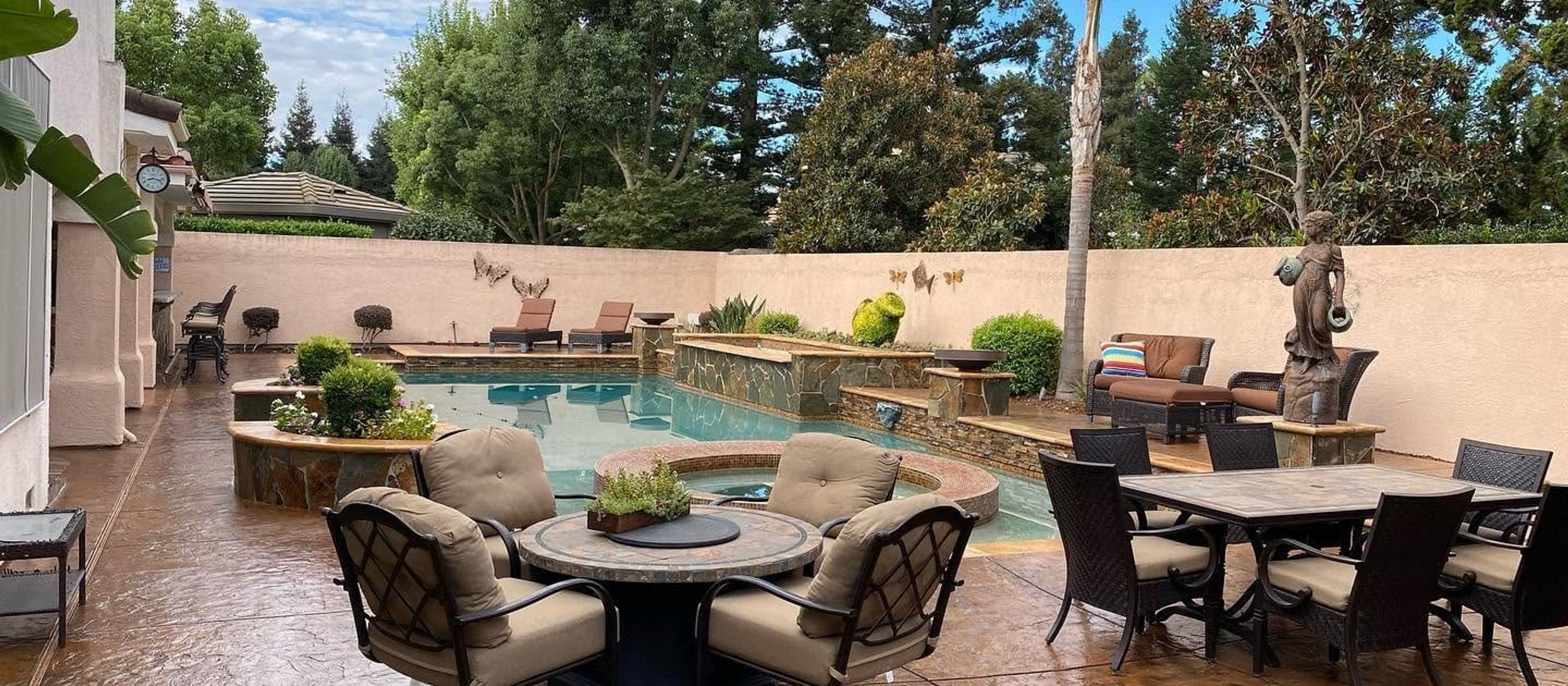 Stained concrete patio around a backyard pool