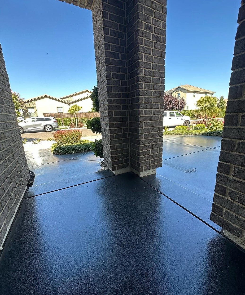 Dark stained and sealed concrete porch at a home entry